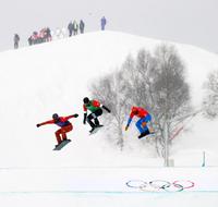 epa09748424 (L-R) Eliot Grondin of Canada, Nick Baumgartner of the USA and Omar Visintin of Italy in action during the Mixed Team Snowboard Cross final at the Zhangjiakou Genting Snow Park at the Beijing 2022 Olympic Games, Beijing municipality, China, 12 February 2022.  EPA/Diego Azubel