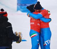 epa09748388 Silver medalists Michela Moioli (C) and Omar Visintin (R) of Italy embrace after the Mixed Team Snowboard Cross final at the Zhangjiakou Genting Snow Park at the Beijing 2022 Olympic Games, Beijing municipality, China, 12 February 2022.  EPA/Diego Azubel