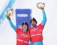 epa09748408 Silver medalists Michela Moioli (L) and Omar Visintin (R) of Italy pose for photographs after the Mixed Team Snowboard Cross final at the Zhangjiakou Genting Snow Park at the Beijing 2022 Olympic Games, Beijing municipality, China, 12 February 2022.  EPA/MAXIM SHIPENKOV