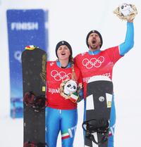 epa09748413 Silver medalists Michela Moioli (L) and Omar Visintin (R) of Italy pose for photographs after the Mixed Team Snowboard Cross final at the Zhangjiakou Genting Snow Park at the Beijing 2022 Olympic Games, Beijing municipality, China, 12 February 2022.  EPA/MAXIM SHIPENKOV