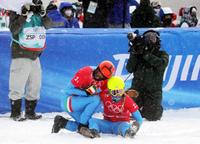 epa09748414 Omar Visintin (C-L) and Michela Moioli (C-R) of Italy rest after the Mixed Team Snowboard Cross final at the Zhangjiakou Genting Snow Park at the Beijing 2022 Olympic Games, Beijing municipality, China, 12 February 2022.  EPA/MAXIM SHIPENKOV